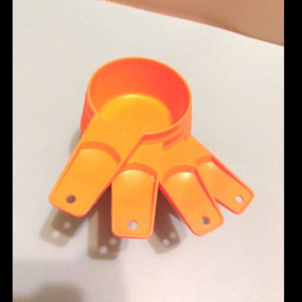 Vintage orange Tupperware measuring cups